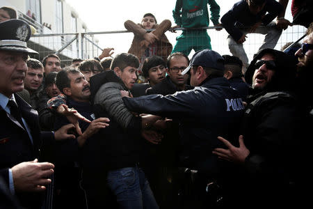 Refugees and migrants, most of them Afghans, are pushed by police officers as they block the entrance of the refugee camp at the disused Hellenikon airport, in Athens, Greece, February 6, 2017. REUTERS/Alkis Konstantinidis