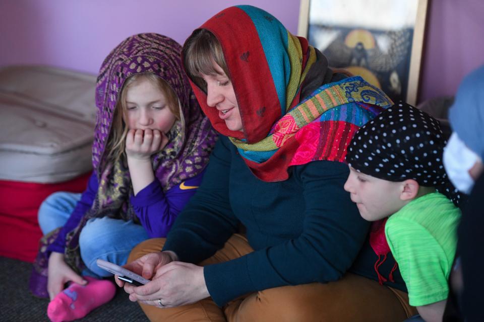 Senior Campus Pastor Ann Rosendale reads a prayer from her phone with her kids on Wednesday, Feb. 28, 2024 at the Augustana University Morrison Commons building in Sioux Falls.