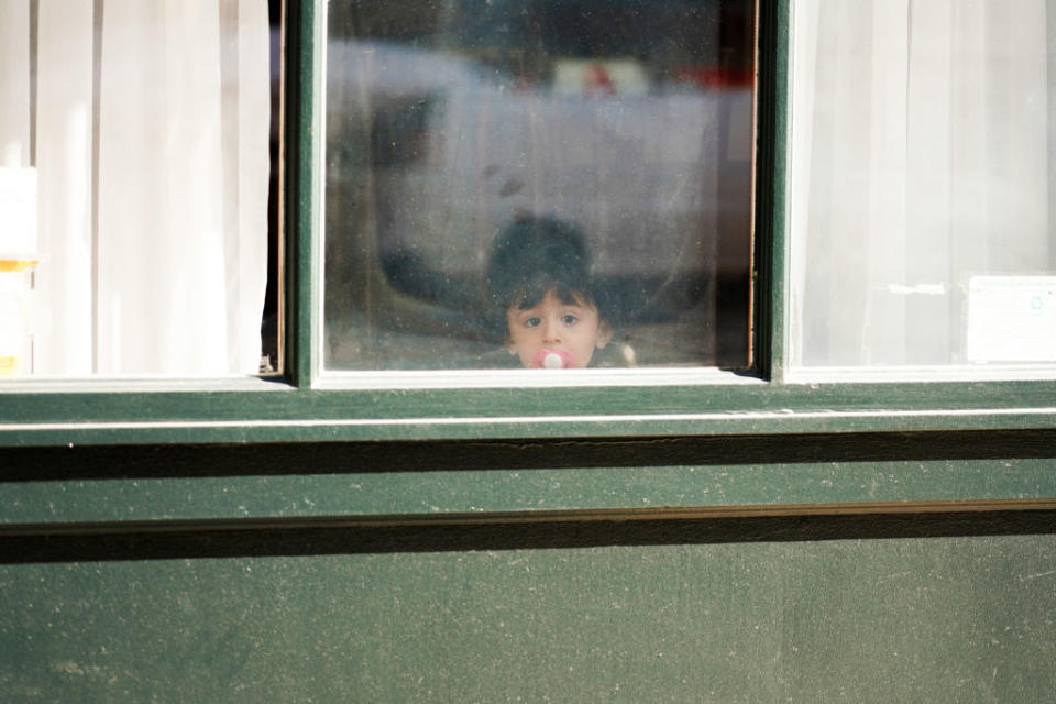 A child looks out a window on March 24, 2020, in New York City. (Cindy Ord/Getty Images)