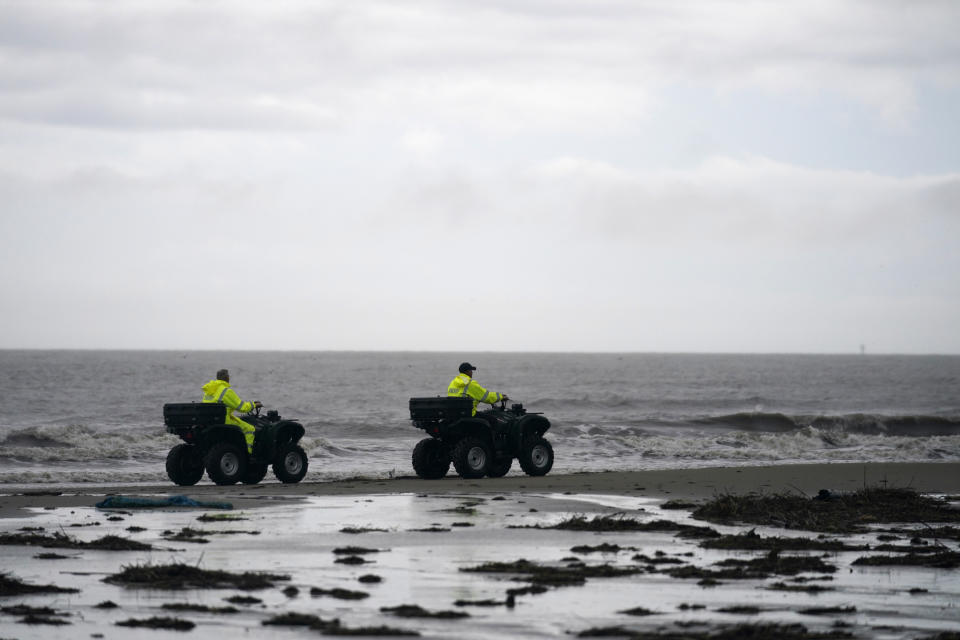 Lafourche Parish deputies patrol along the shoreline of the Gulf of Mexico, not far from where a lift boat capsized during a storm on Tuesday, killing one with 12 others still missing, on Elmer's Island, La., Thursday, April 15, 2021. (AP Photo/Gerald Herbert)