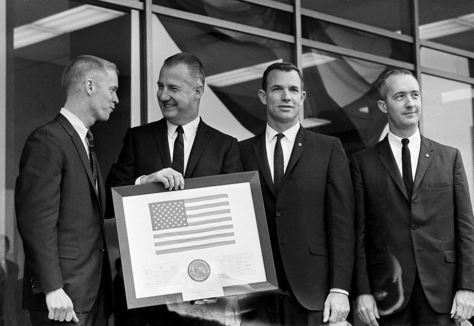 FILE - Vice President Spiro Agnew holds a framed American flag, presented to him by the crew of Apollo 9, as he poses with the astronauts March 26, 1969, in Washington. From left: Russell Schweikart, Agnew, and Air Force Cols. David Scott and James McDivitt. McDivitt, who commanded the Apollo 9 mission testing the first complete set of equipment to go to the moon, died Thursday, Oct. 13, 2022. He was 93. (AP Photo/Harvey Georges, File)