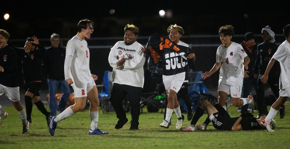 Members of the Lely boys soccer team celebrates a 1-0 win over Mariner at Mariner during a regional game on Tuesday, Feb. 13, 2024.