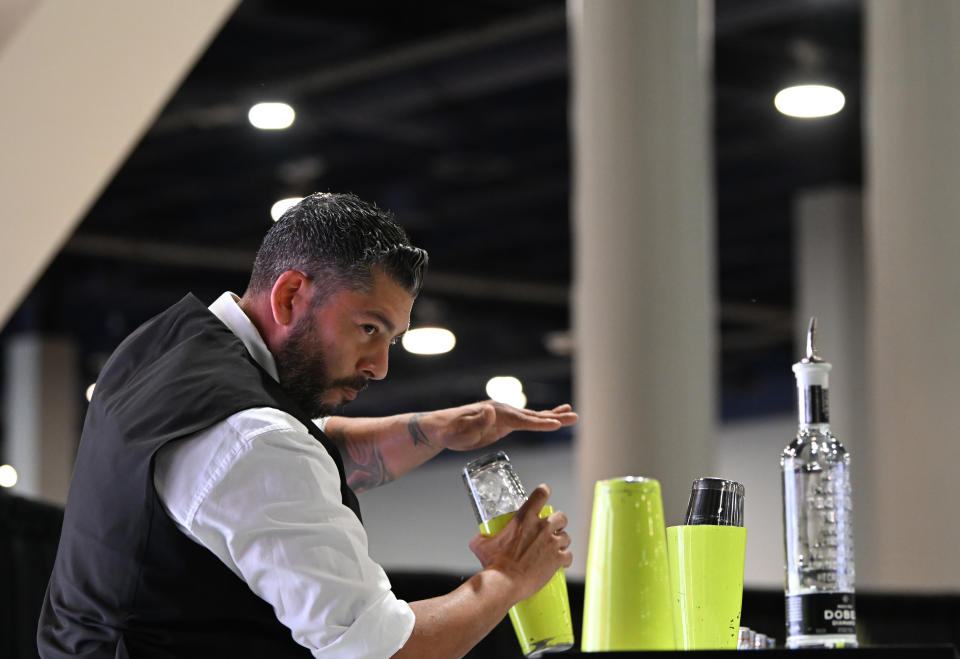 LAS VEGAS, NEVADA – MARCH 20: Manny Picon Delgado demonstrates Flare Bartending onstage during the United States Bartenders Guild Shake it Up Championship on Day 3 of the 2024 Bar & Restaurant Expo at the Las Vegas Convention Center on March 20, 2024 in Las Vegas, Nevada. (Photo by Bryan Steffy/Getty Images for Nightclub & Bar Media Group)