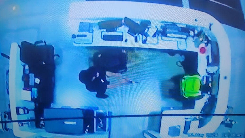 West Jefferson police Chief Brandon Smith said this is an image from a security camera at the Amazon warehouse in his Madison County community on Sunday showing security guard trainee and shooting suspect Ali Hamsa Yusuf, 22, pointing a gun at his supervisor.