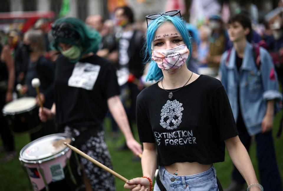 A protester holding a drum stick reacts during the protest today (REUTERS)