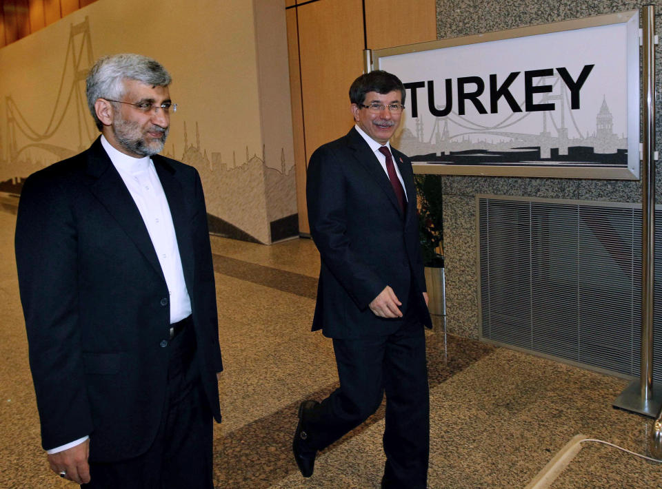 Turkey's Foreign Minister Ahmet Davutoglu, right, and Iran's Chief Nuclear Negotiator Saeed Jalili arrive for meeting in Istanbul, Turkey, Saturday, April 14, 2012. After years of failure, Iran and the six world powers may finally make some progress on nuclear negotiations when they meet again Saturday if each side shows willingness to offer concessions the other seeks.(AP Photo/Tolga Adanali, Pool)