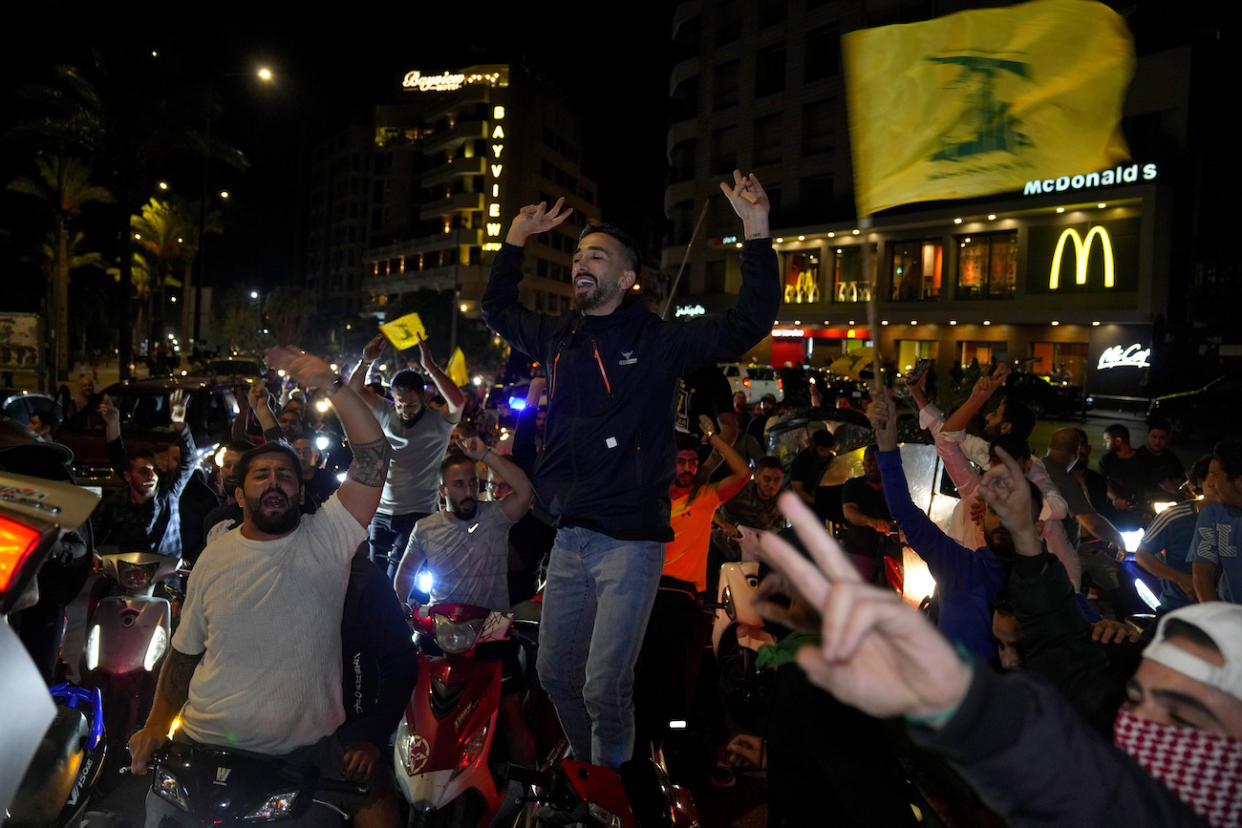Hezbollah supporters chant slogans as they wave the group's flag during a protest in solidarity with the Palestinian people in Gaza, in Beirut, Lebanon, Tuesday, Oct. 17, 2023. (PHOTO: AP Photo/Bilal Hussein)