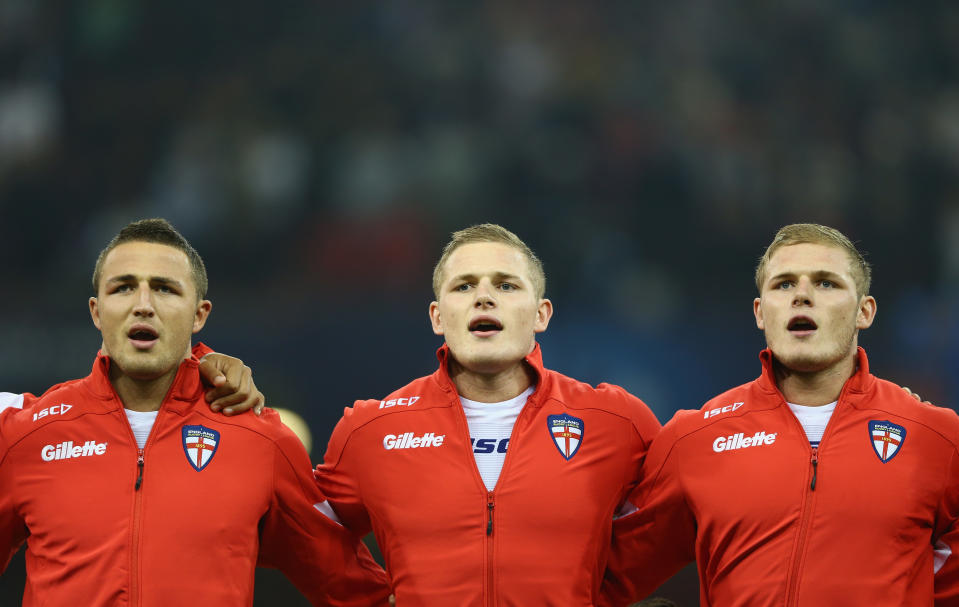 CARDIFF, WALES - OCTOBER 26:  Sam Burgess (L) George Burgess (C) and Tom Burgess (R) of England sing the national anthem during the Rugby League World Cup Group A match between Australia and England at the Millennium Stadium on October 26, 2013 in Cardiff, Wales.  (Photo by Michael Steele/Getty Images)