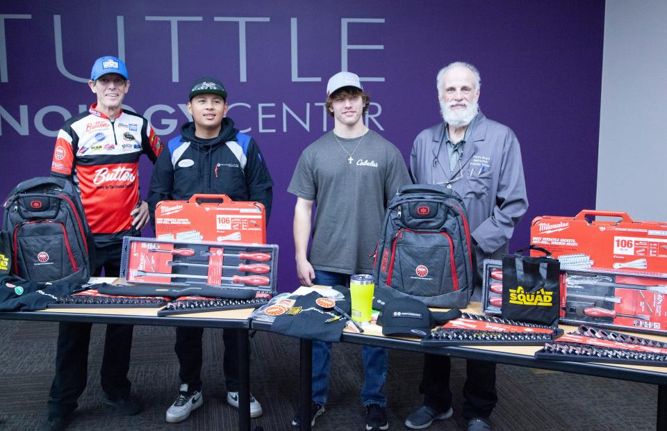 NHRA Pro-Stock Racer Steve Johnson, students Isaac Sirisombath and Michael Van Zandt, and Instructor Steve Boyd pose with the students’ reward for winning the national Steve Johnson Racing Scholarship.