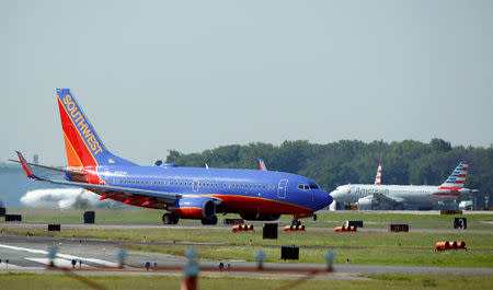 A Southwest Airlines jet taxis on the runway at Washington National Airport in Washington, U.S., August 9, 2017. REUTERS/Joshua Roberts