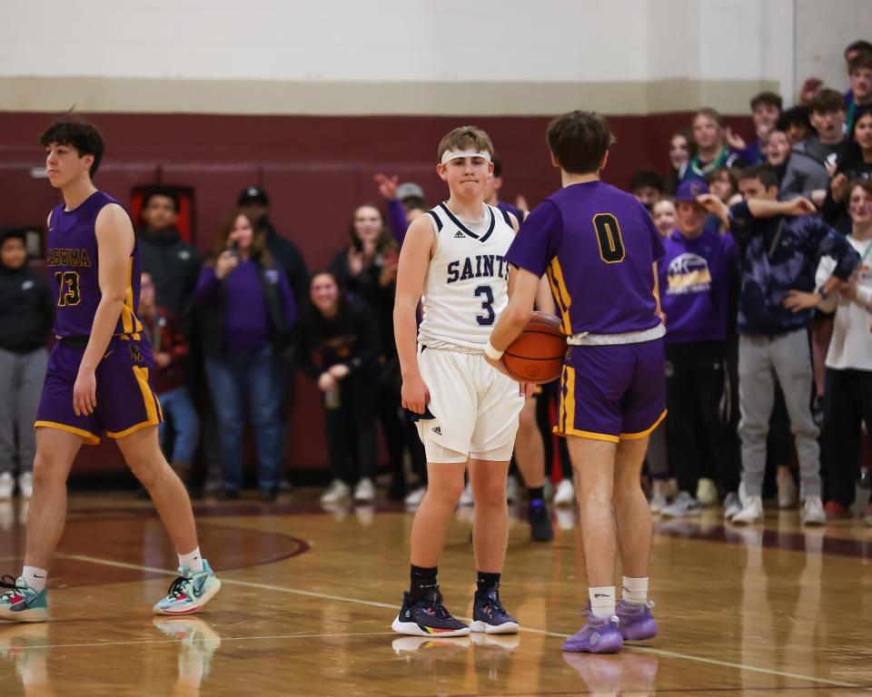 St. Thomas Aquinas sophomore Anthony Settineri makes no attempt to take the ball from Mascoma's Aidan Bassett as the final seconds tick off the clock during Wednesday's Division III boys basketball semifinal at Goffstown High School.