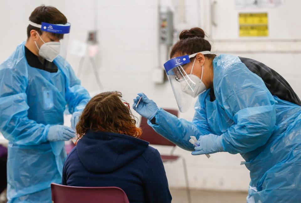 Angela Hanson, right, a certified medical assistant with the Springfield-Greene County Health Department, administers a COVID-19 test on Friday, Jan. 7, 2022 in Springfield, Mo.