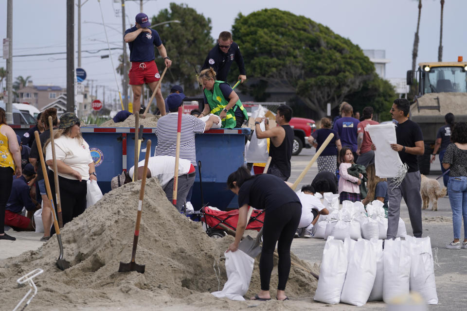 Long Beach lifeguards fill up sandbags for residents ahead of Hurricane Hilary, in Long Beach, Calif., Saturday, Aug. 19, 2023. (AP Photo/Damian Dovarganes)