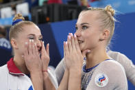 Russian Olympic Committee's artistic gymnastics women's team Liliia Akhaimova, left, and Angelina Melnikova celebrate after winning the gold medal for the artistic women's team at the 2020 Summer Olympics, Tuesday, July 27, 2021, in Tokyo. (AP Photo/Ashley Landis)