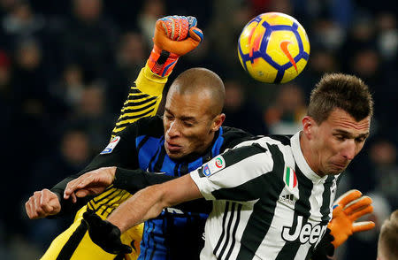 Soccer Football - Serie A - Juventus vs Inter Milan - Allianz Stadium, Turin, Italy - December 9, 2017 Juventus’ Mario Mandzukic in action with Inter Milan's Miranda REUTERS/Stefano Rellandini