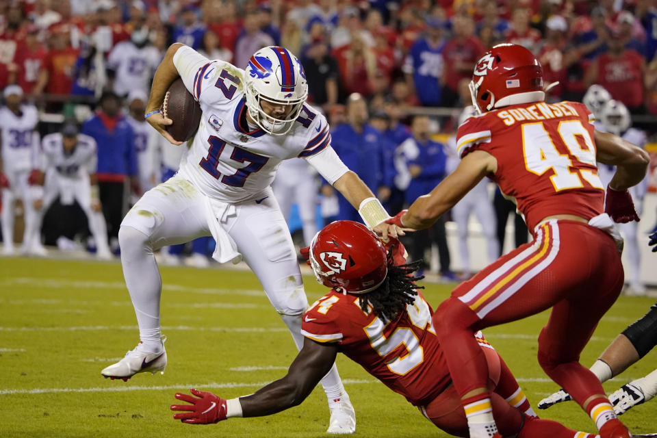 Buffalo Bills quarterback Josh Allen (17) runs with the ball as Kansas City Chiefs linebacker Nick Bolton (54) and safety Daniel Sorensen (49) defend during the first half of an NFL football game Sunday, Oct. 10, 2021, in Kansas City, Mo. (AP Photo/Ed Zurga)