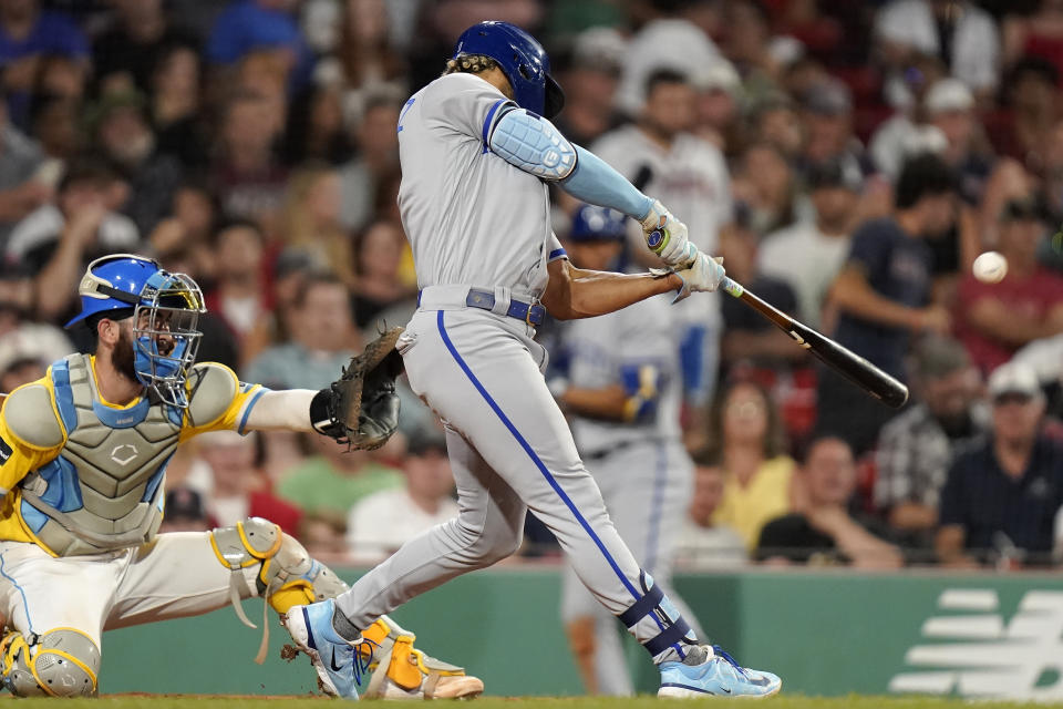 Kansas City Royals' MJ Melendez, right, hits a two-run home run next to Boston Red Sox catcher Connor Wong during the sixth inning of a baseball game Tuesday, Aug. 8, 2023, in Boston. (AP Photo/Steven Senne)