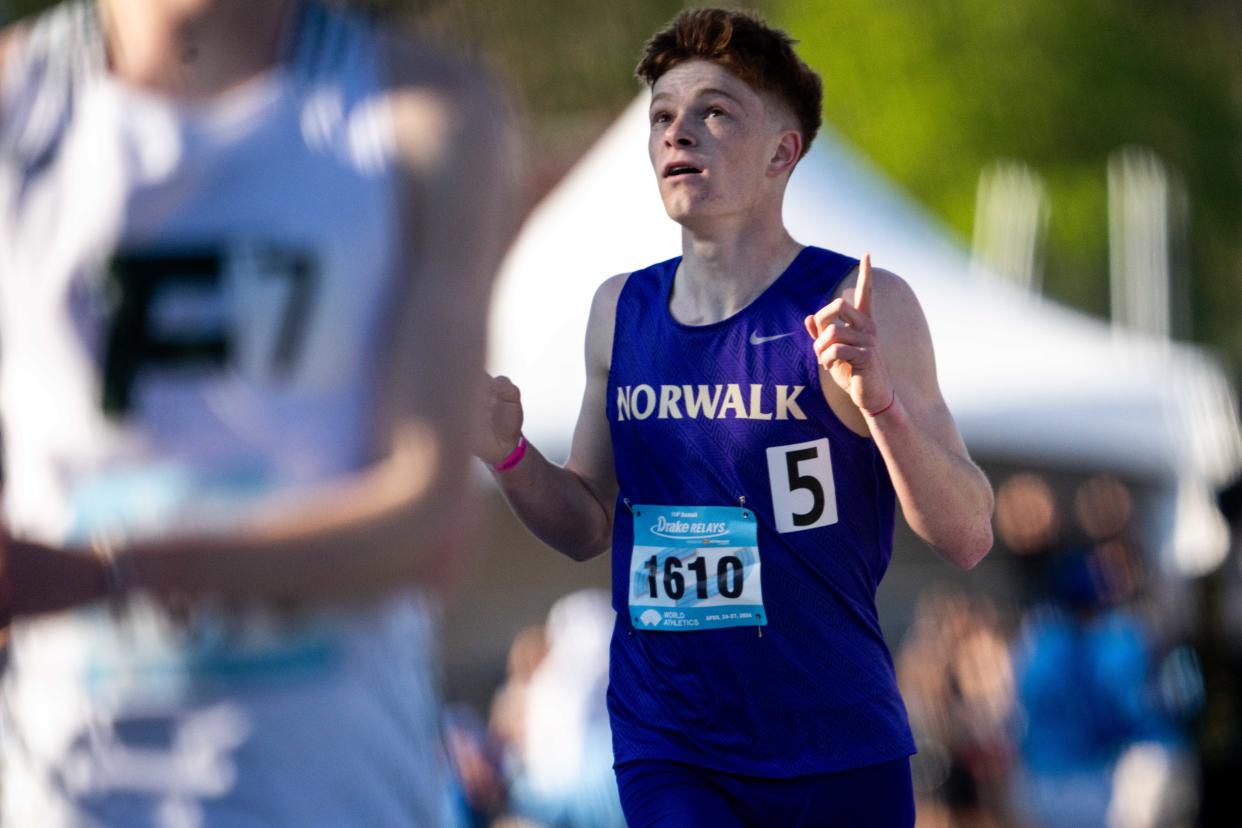 Norwalk's Tony Anania points to the sky after finishing the 3200 during the Drake Relays on Thursday. He finished the race fifth and with a new PR.