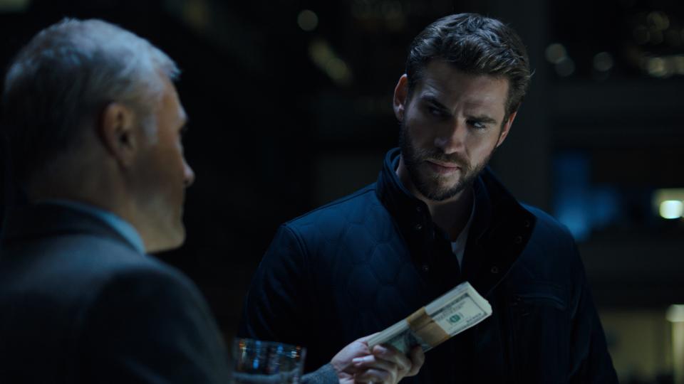 This image released by Quibi shows Christoph Waltz, left, and Liam Hemsworth in a scene from "Most Dangerous Game." Hemsworth stars as a father-to-be with huge bills and a terminal illness in this high-end thrilling series that feels like watching a big-budget film. Waltz plays a man with an intriguing offer for our hero: Be prey for a bunch of hunters and leave your wife and child millions. (Quibi via AP)
