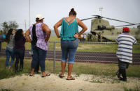 <p>Local residents watch after a U.S. Army helicopter landed during food and water delivery efforts four weeks after Hurricane Maria struck on Oct. 18, 2017 in Utuado, Puerto Rico. U.S. soldiers and agents delivered supplies provided by FEMA to remote residents in mountainous Utuado. (Photo: Mario Tama/Getty Images) </p>