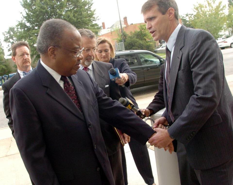 Former U.S. Rep. Frank Ballance is handcuffed by FBI special agent Chuck Stuber after he turned himself in at the United States District Court building in Raleigh.