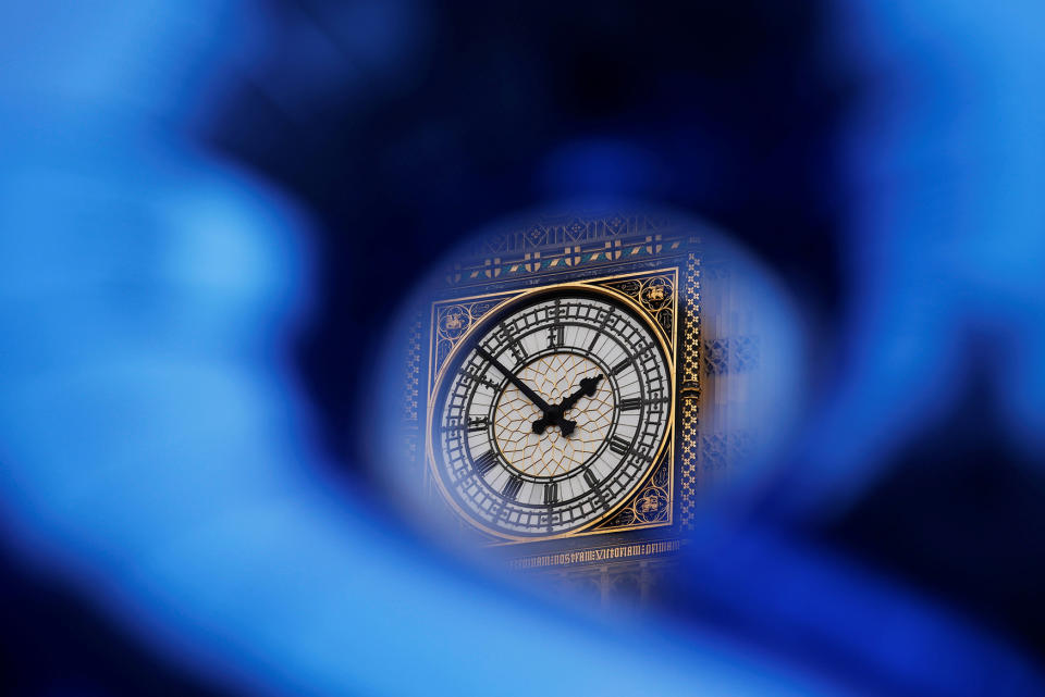 The Big Ben bell tower is visible through a shaped foil balloon