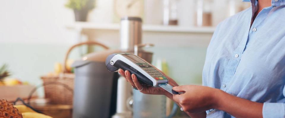 woman inserting credit card into card reader