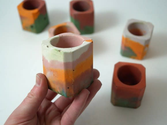 Several multicolored candle holders available on Etsy.