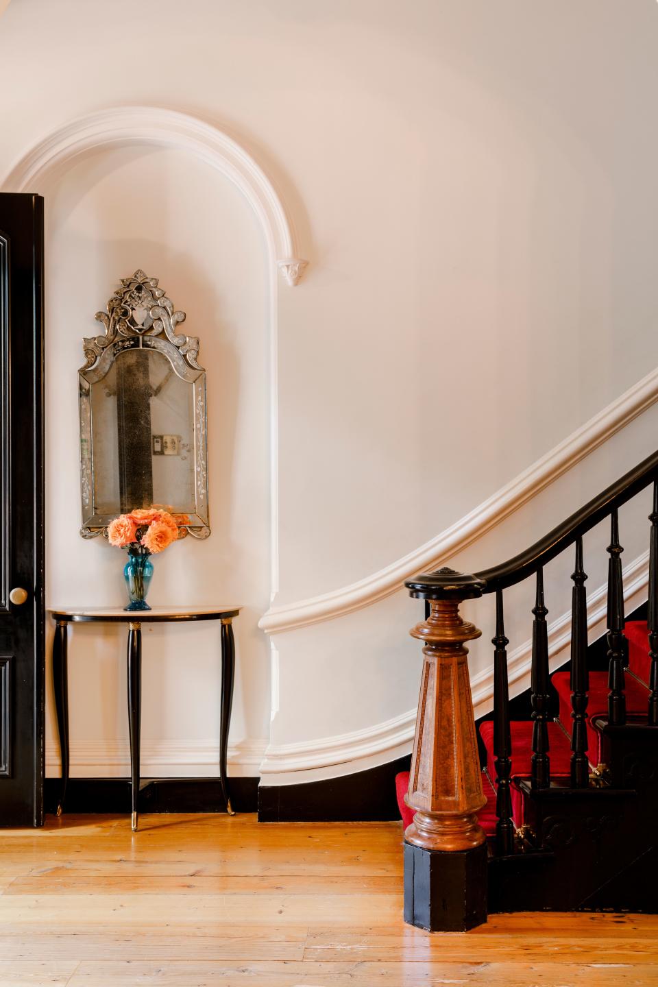 “We researched the different cornices and moldings from the period in which the house had been built, ones in the Italianate style and then, picked ones we liked,” says Tyler of having to entirely re-create the home’s foyer, floor to ceiling. “That is how the staircase looked, though” she recalls. “And we kept that one piece of the banister, with the stripped down original wood, just like that. We hid a set of plans for the house in there!”