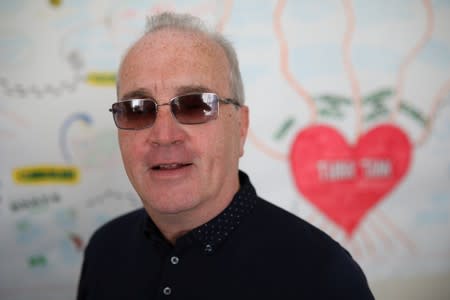 Richard Moore, CEO of Children in the Crossfire, who was struck by a rubber bullet that hit him and left him blind when he was 10 years old poses for a photograph in Londonderry, Northern Ireland