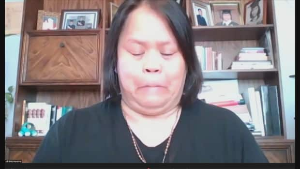 Candida Macarine's daughter Gilda holds back tears during an online news conference Monday.