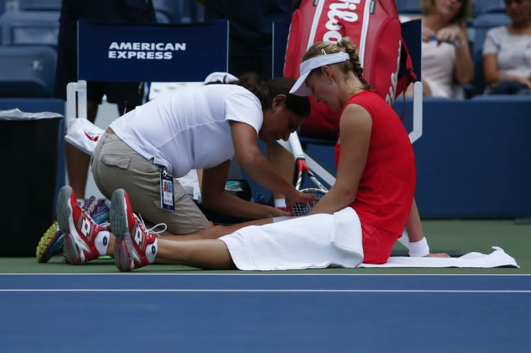 Ekaterina Makarova of Russia receives medical assistance as she plays against Elina Svitolina of Ukraine during their 2015 US Open Women's Singles match on September 4, 2015, in New York