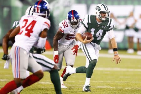 Aug 24, 2018; East Rutherford, NJ, USA; New York Jets quarterback Sam Darnold (14) rushes for a first down against the New York Giants during first half at MetLife Stadium. Mandatory Credit: Noah K. Murray-USA TODAY Sports