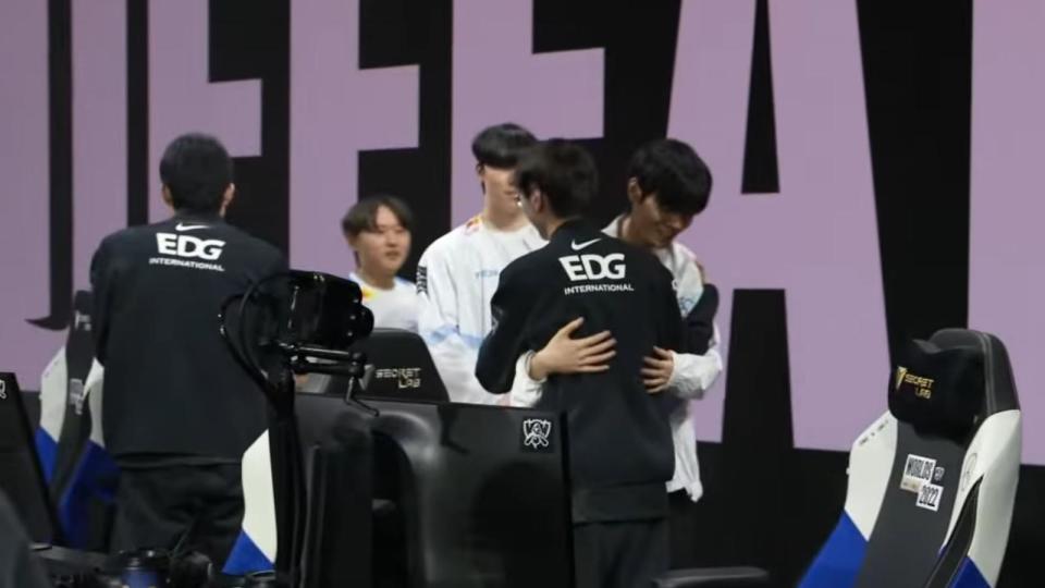 Deft gives hugs to his former teammates, Scout and Meiko, after winning the quarterfinals. (Photo: Riot Games)