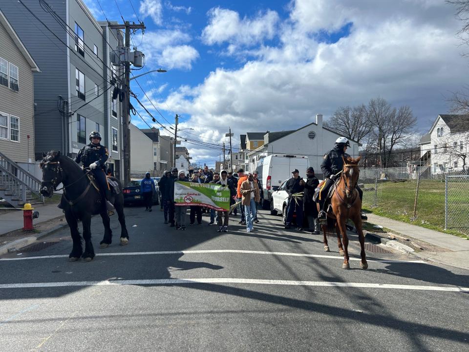 Operation Ceasefire marchers walk down Auburn Street Saturday, April 6, in Paterson's Fourth Ward during the annual peace event.