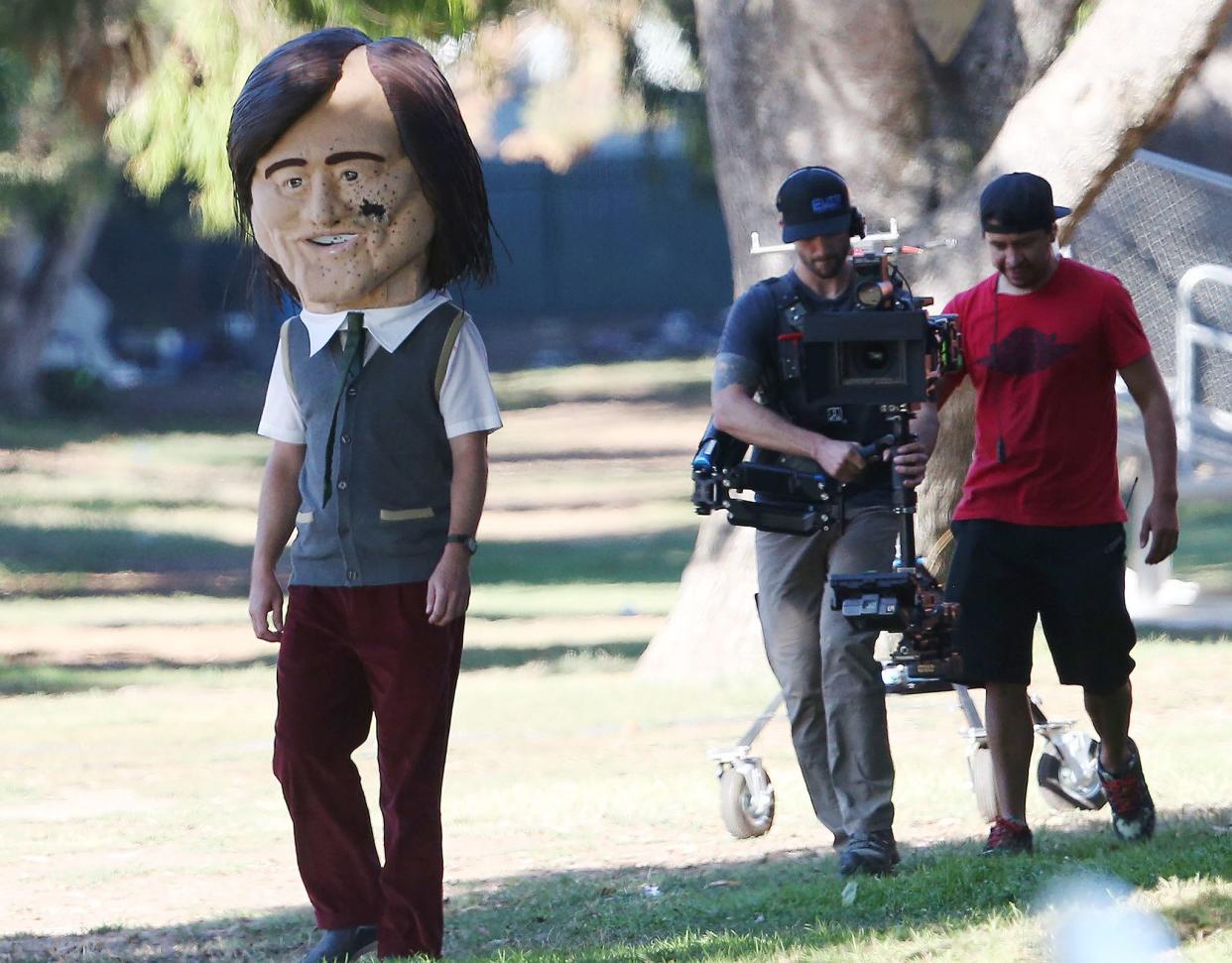 Carrey was seen in two different outfits during filming, all while still wearing the oversized papier mache head.