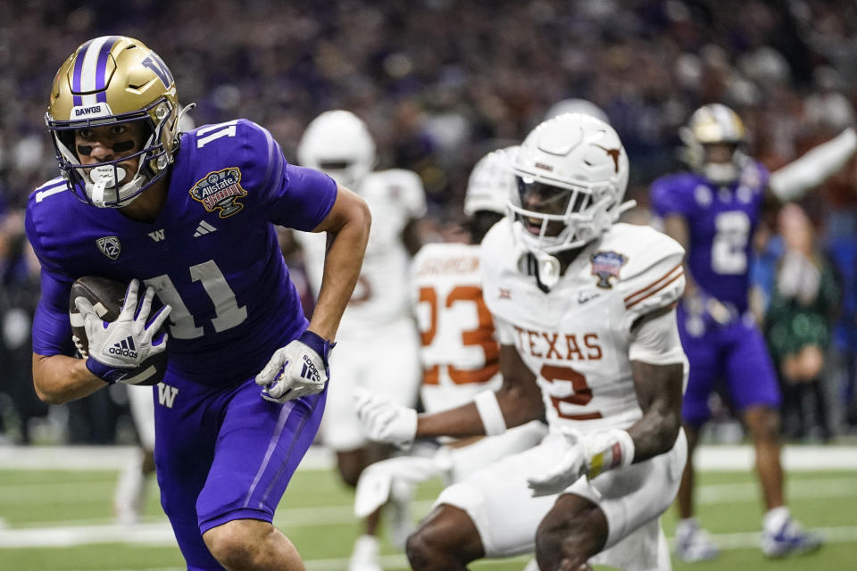 Washington wide receiver Jalen McMillan (11) makes a touchdown catch against Texas during the second half of the Sugar Bowl CFP NCAA semifinal college football game, Monday, Jan. 1, 2024, in New Orleans. (AP Photo/Gerald Herbert)