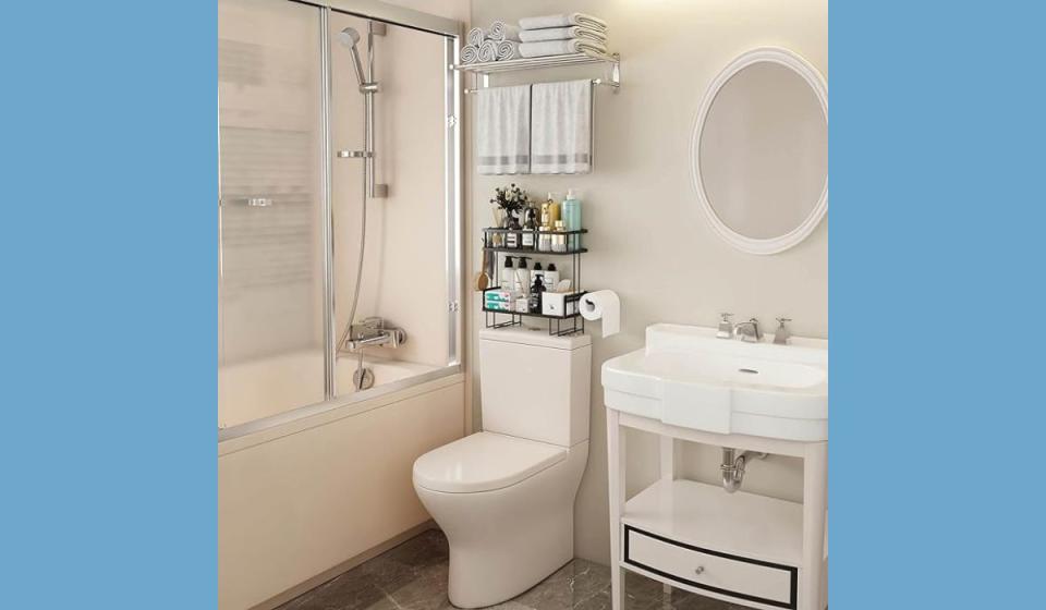 Bathroom with two-tiered storage unit above toilet.