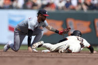 San Francisco Giants' Austin Slater (13) is tagged out attempting to steal second base by Washington Nationals second base Luis García Jr., left, during the second inning of a baseball game in San Francisco, Wednesday, April 10, 2024. (AP Photo/Jed Jacobsohn)