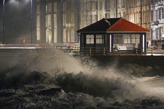 Waves crash against the sea wall in Aberystwyth in west Wales (Aaron Chown/PA)