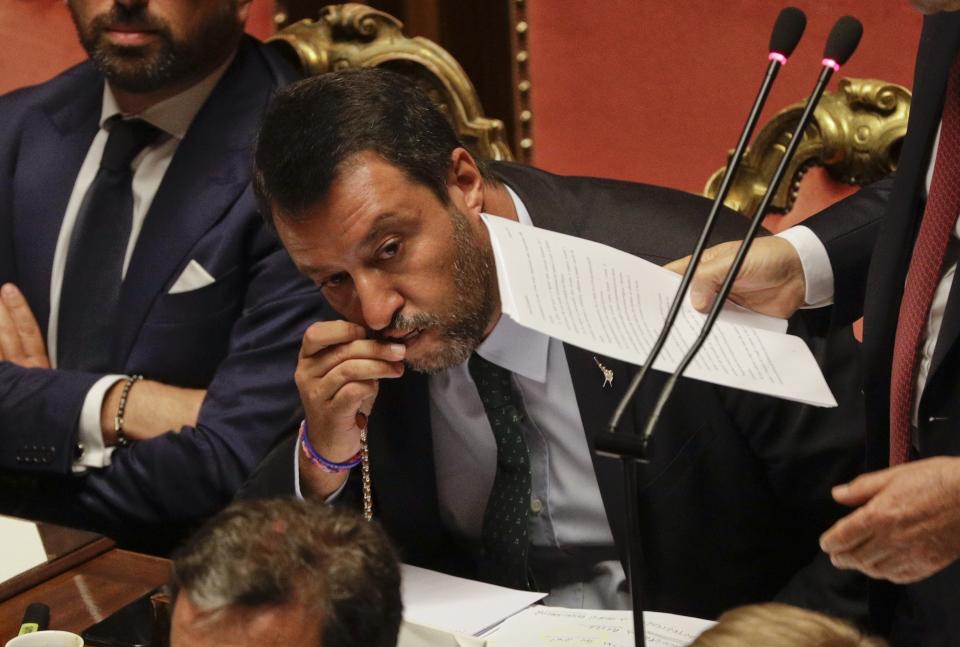 Italian Deputy-Premier Matteo Salvini kisses a rosary as Premier Giuseppe Conte addresses the Senate in Rome, Tuesday, Aug. 20, 2019. The political showdown on Tuesday was triggered two weeks ago by hard-line Interior Minister Matteo Salvini, known across Europe for his tough stance against migrants, when he pulled the plug on the shaky populist coalition forged only 14 months earlier between his right-wing League and the anti-establishment 5-Star Movement. (AP Photo/Gregorio Borgia)