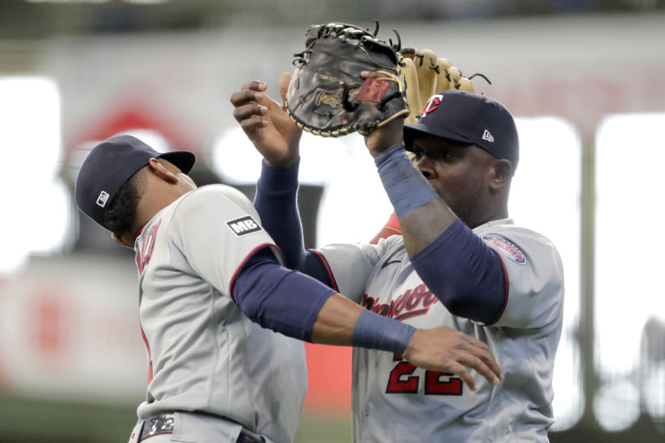 Minnesota Twins' Miguel Sano, right, catches a fly ball while colliding with Jorge Polanco during the second inning of an Opening Day baseball game against the Milwaukee Brewers Thursday, April 1, 2021, in Milwaukee. (AP Photo/Aaron Gash)