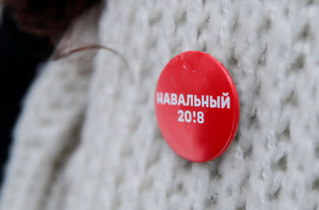 A badge of Russian opposition leader Alexei Navalny's activist and supporter, who is walking through a housing estate and putting up fliers to promote a boycott of the upcoming presidential election, is seen in Moscow, Russia February 10, 2018. Picture taken February 10, 2018. REUTERS/Maxim Shemetov