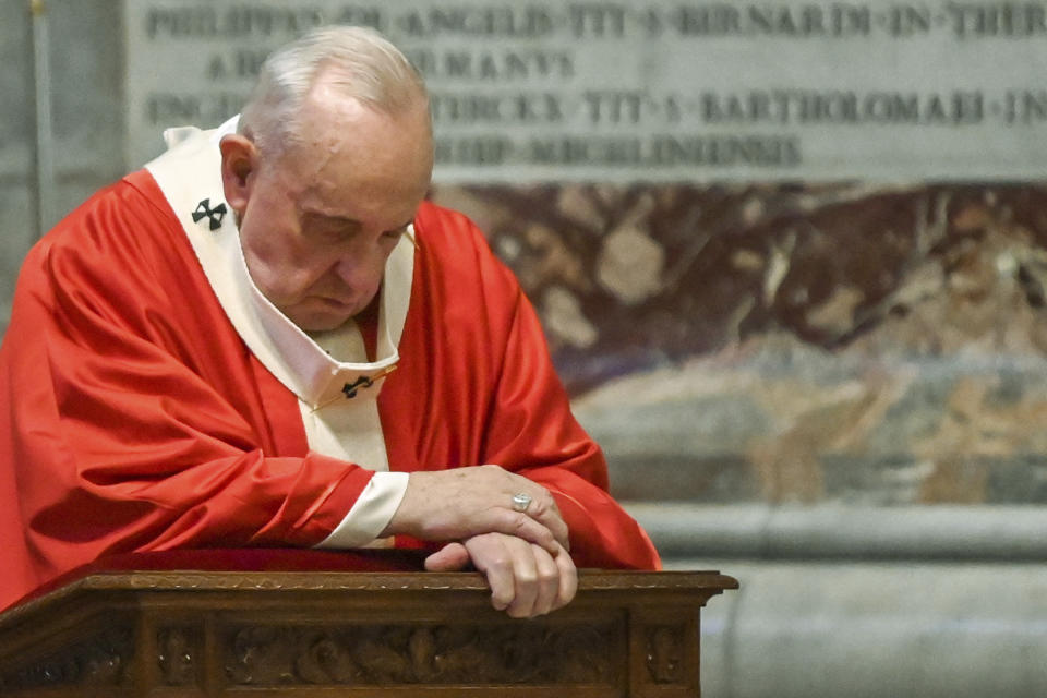 Pope Francis prays as he celebrates Palm Sunday Mass behind closed doors in St. Peter's Basilica, at the Vatican, Sunday, April 5, 2020, during the lockdown aimed at curbing the spread of the COVID-19 infection, caused by the novel coronavirus. (AP Photo/pool/Alberto Pizzoli)