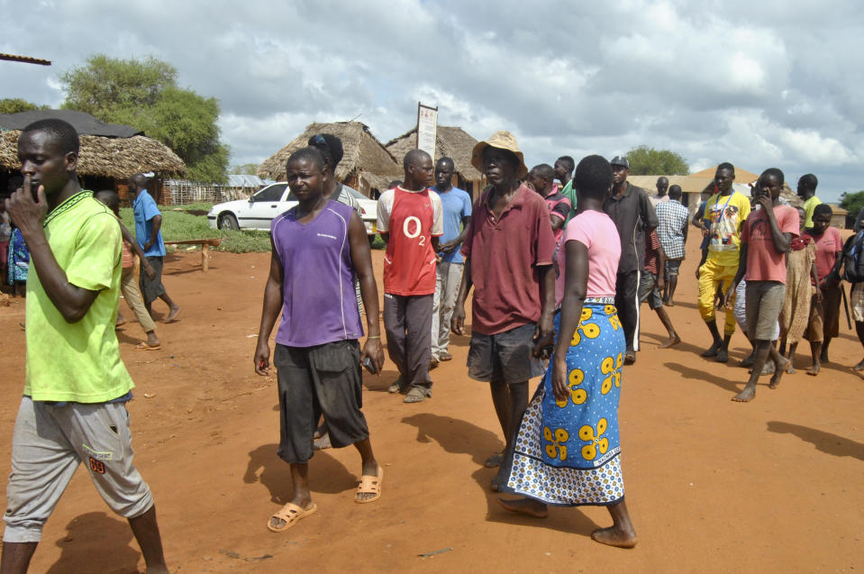 Villagers gather on the streets in the village of Chakama, where gunmen kidnapped an Italian volunteer, in coastal Kilifi county, Kenya Wednesday, Nov. 21, 2018. Gunmen shot indiscriminately, kidnapped the Italian woman and wounded a number of Kenyans late Tuesday according to police. (AP Photo)