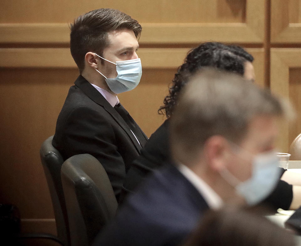 Chandler Halderson sits in Dane County Circuit Court in Madison, Wis. during the opening of his trial Tuesday, Jan. 4, 2022. Halderson, 23, faces charges of first-degree intentional homicide and mutilating and hiding a corpse related to the death of his parents, Bart and Krista Halderson last July. (John Hart/Wisconsin State Journal via AP)