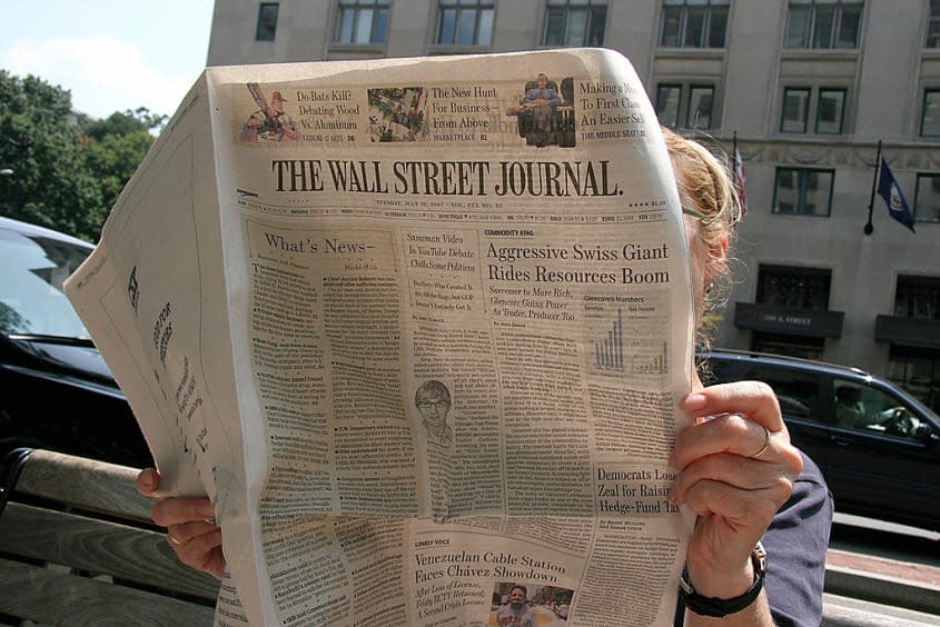 A woman reads The Wall Street Journal.