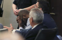 Defendant Otis McKane places his head in his hands after the jury came back with a guilty verdict in his capital murder trial for the 2016 shooting of San Antonio police detective Benjamin Marconi on Monday, July 26, 2021, in San Antonio. (Kin Man Hui/The San Antonio Express-News via AP)