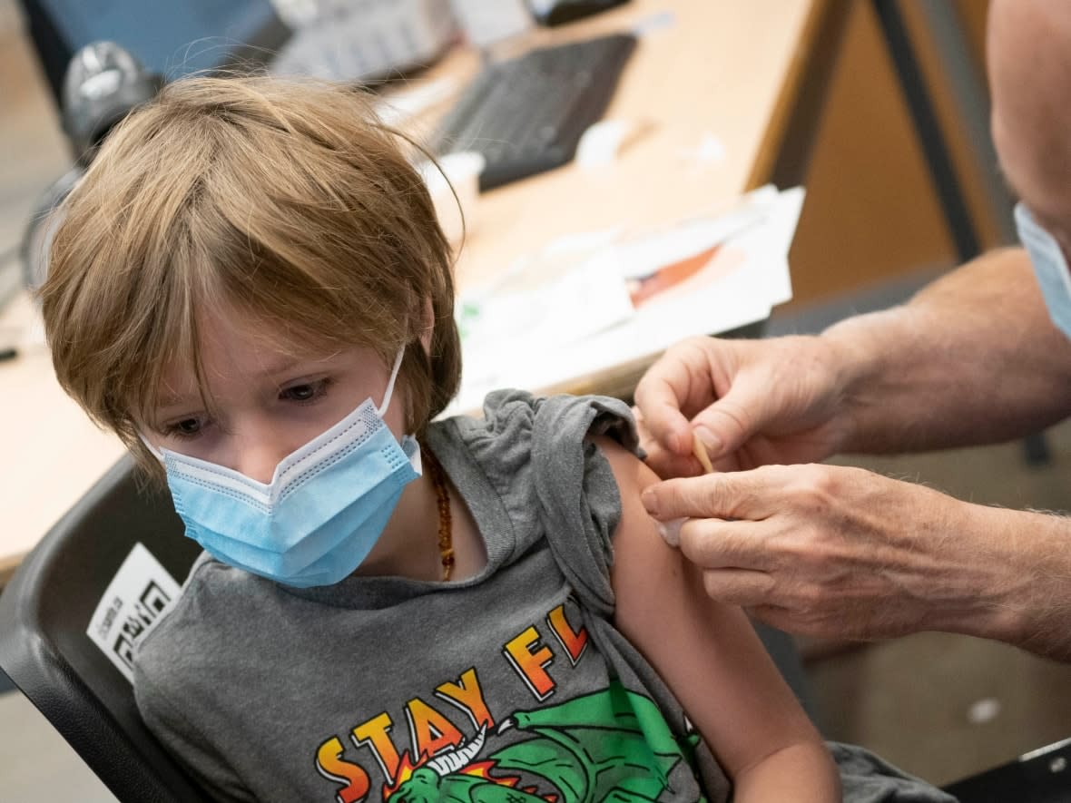 A boy gets his vaccine against COVID-19 in Montreal on Wednesday. Nearly 43,000 vaccination appointments were booked Wednesday for Alberta children. (CBC / Radio-Canada - image credit)