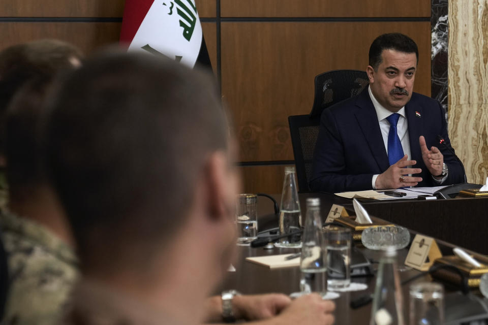 Iraqi Prime Minister Mohammed Shia al-Sudani, right, chairs the first session of negotiations between Iraq and the United States to wind down the International Coalition mission in Baghdad, Iraq, Saturday, Jan. 27, 2024. (AP Photo/Hadi Mizban, Pool)